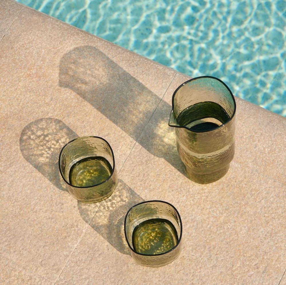 Handmade olive green drinking glasses and glass carafe