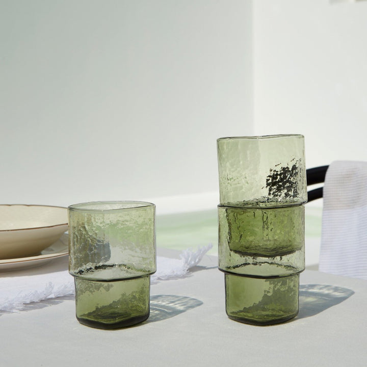 Stackable olive-green handmade drinking glasses with hammered texture