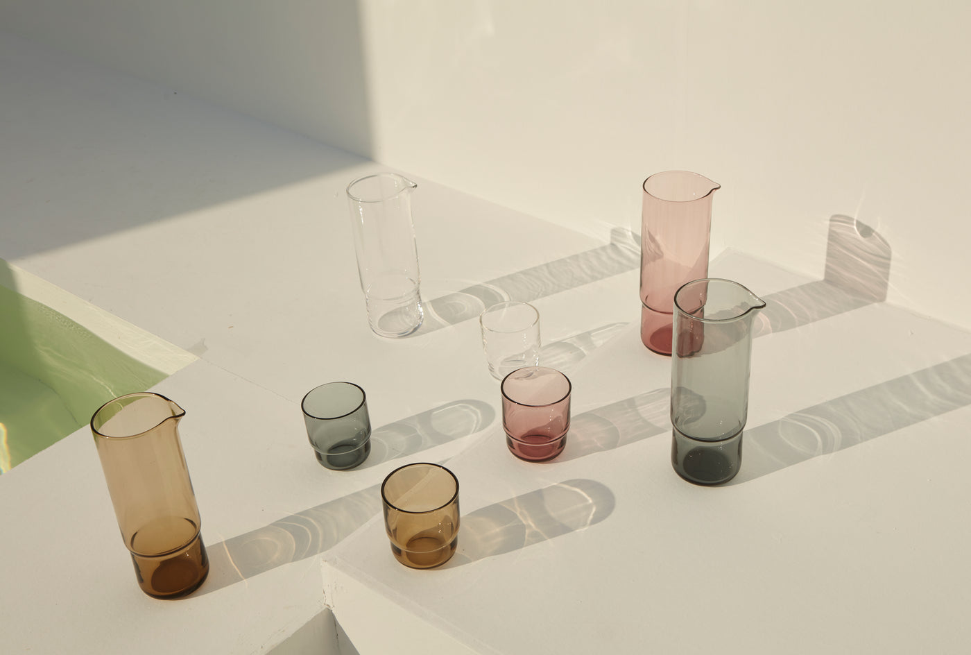 Handmade, stackable, coloured glasses with matching carafe