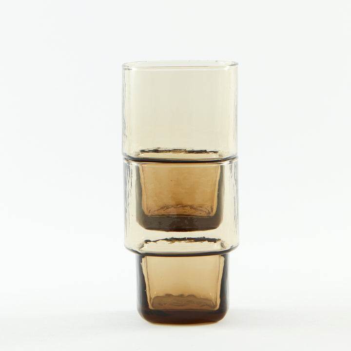 Stackable brown handmade drinking glasses with a unique shape and hammered texture 