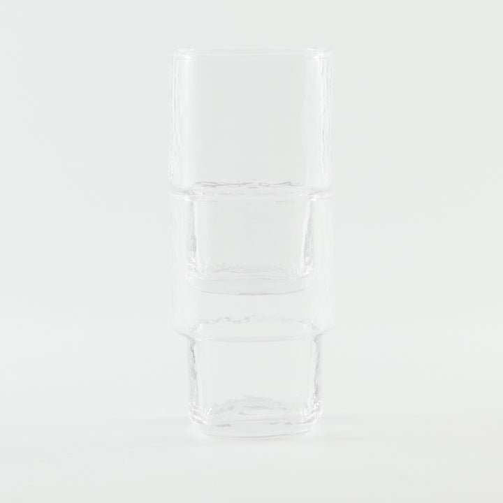Stackable brown handmade drinking glass with a unique form and hammered texture
