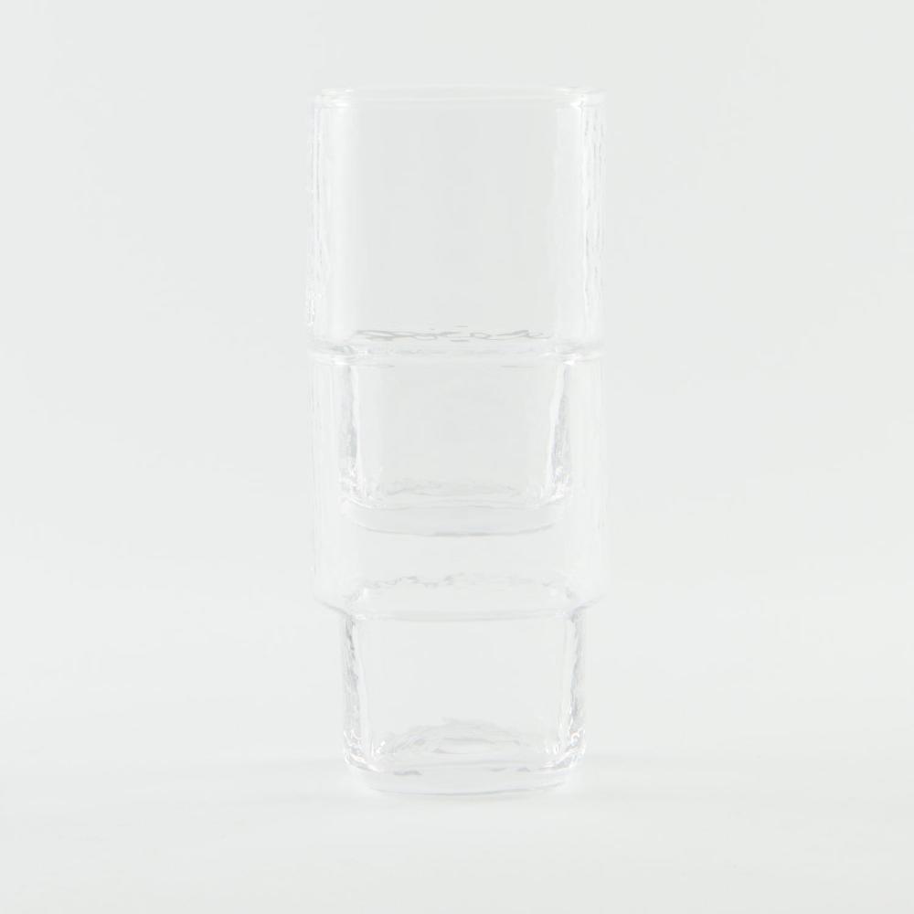 A set of 2 stackable, slim, clear handmade drinking glass with angular shape and hammered texture
