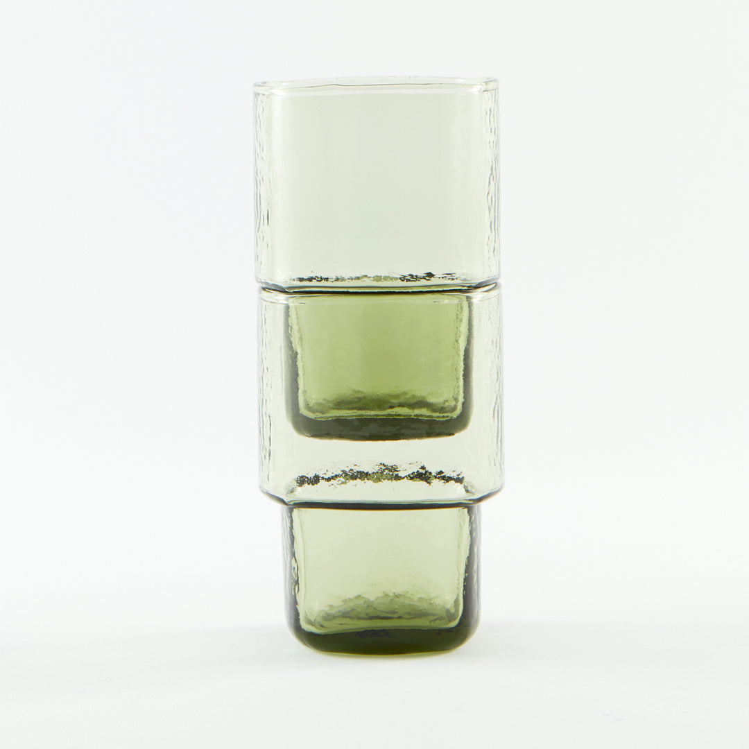 Stackable olive-green handmade drinking glass with a unique form and hammered texture 