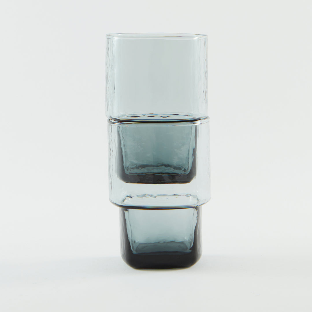 Unique, stackable handmade drinking glasses with an unusual shape and hammered texture in smoke grey