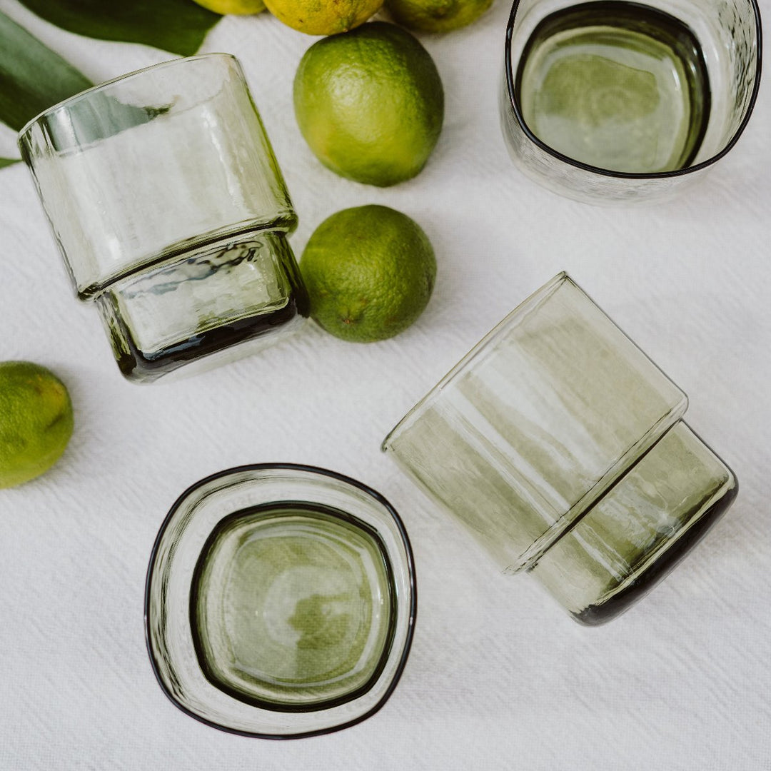 A set of 4 modern, big, stackable coloured handmade drinking glass in olive green