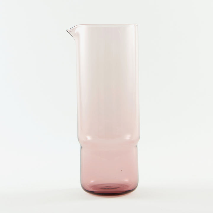 A stylish 1 litre cylindrical handmade glass carafe in pastel mulberry pink