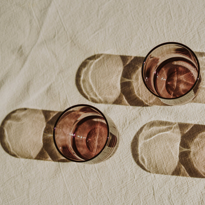 Shadow of round drinking glasses in pastel pink