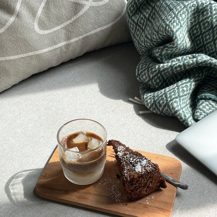 Iced coffee in a glass and a chocolate cake