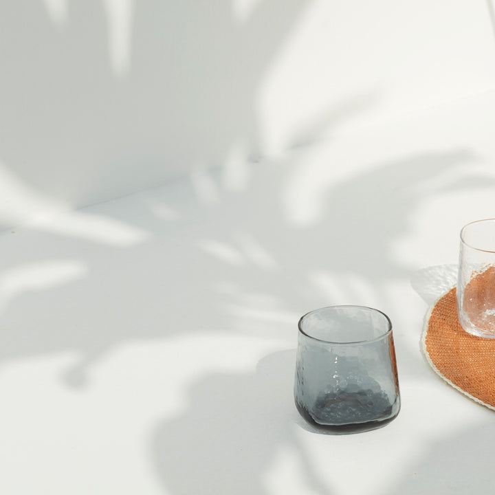 Blue-grey minimalistic drinking glass with a unique shape