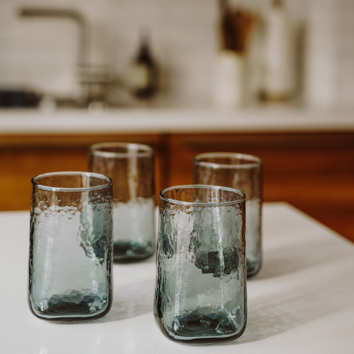 A set of 4 smoke grey big drinking glasses in a modern kitchen